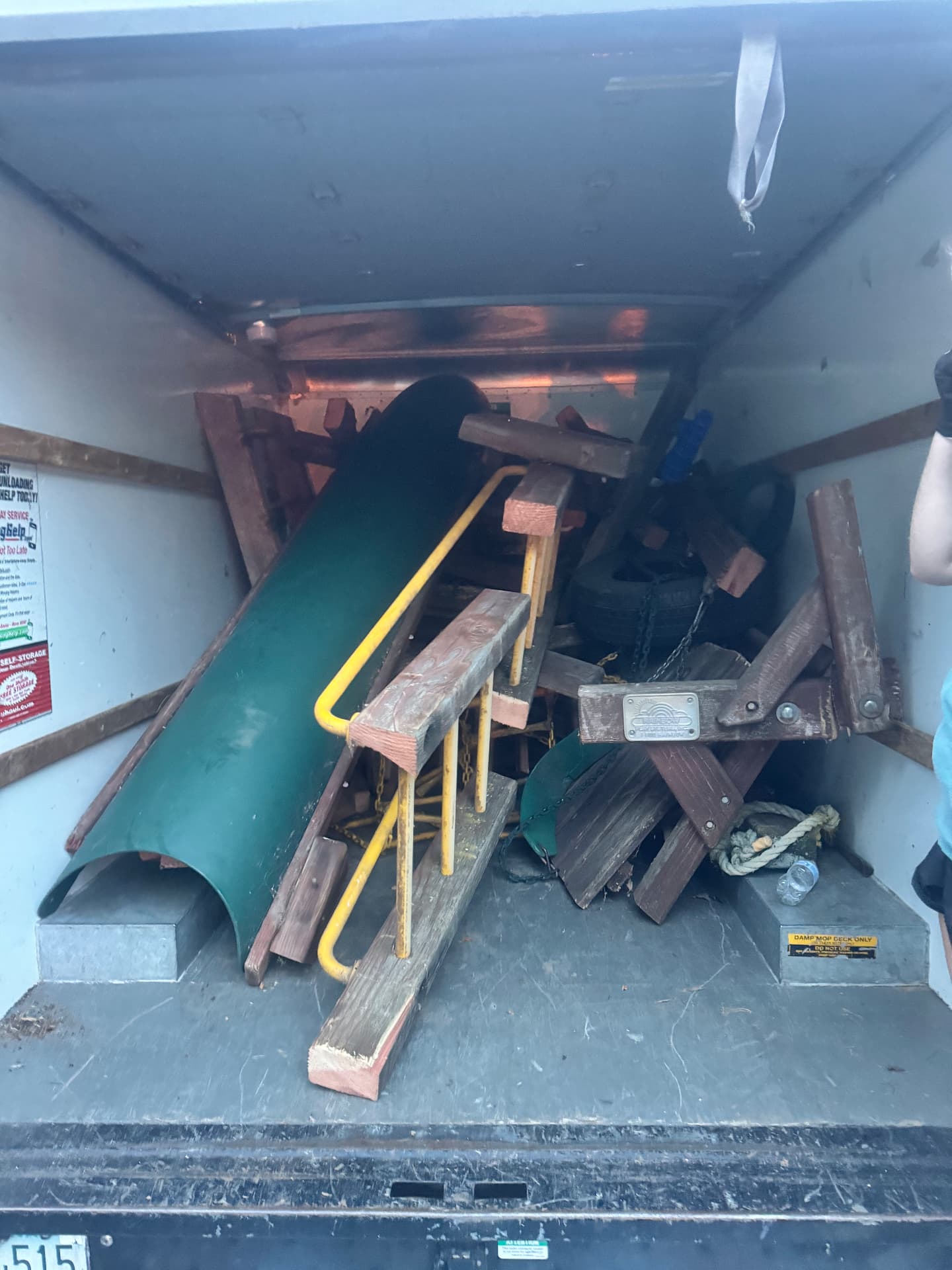 Dismantled wooden playset loaded for haul-away